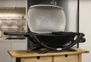 weber q2000 grill on the table